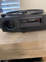 Close-up of Kodak Carousel 750H projector front showing lens and branding