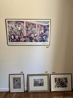 Four framed art pieces arranged on a wall and floor, showing a colorful bar scene and three additional varied prints