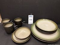 Full lot overview: 2 dinner plates, 3 salad plates, 1 dessert plate, 1 ice cream bowl, 3 mugs on black background