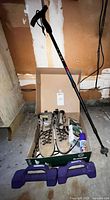 Full lot overview showing hiking boots, socks, waterproofing spray, walking stick, and weights arranged together