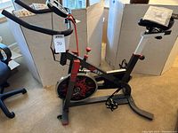 Full side view of the VIGBODY exercise bike showing frame, seat, handlebars and digital display.