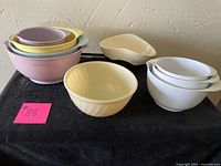 Overview of all bowls included in the lot on a black surface