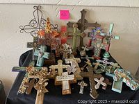 Table display showing a collection of crosses in different materials and sizes.