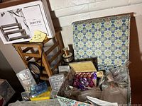 Photo showing various bead containers including a decorative box with assorted beads, magnifying glass, and storage boxes.