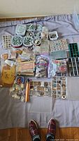 Overall view of assorted jewelry making supplies laid out on fabric