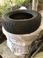 Stack of bagged tires with one tire on top