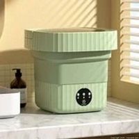 green collapsible washing machine on countertop showing control panel