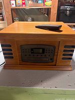 Front view of Crosley CR78CD unit with remote on top