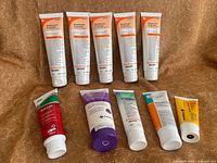 Nine tubes of skin barrier creams on fabric surface