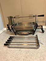 Full broiler with stand, pan, spit, motor, skewers visible