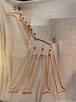 Full view of orange metal giraffe coat rack