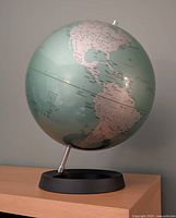 Full view of globe on black base showing Americas