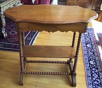 Front view of entire side table showing drawer, legs, lower shelf