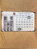 Front view showing Notre Dame design, calendar grid, and magnetic month/date tiles