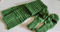 Green wool rib-knit scarf and matching convertible mittens laid flat