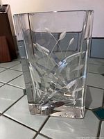 Front view showing etched leaf design on clear glass vase