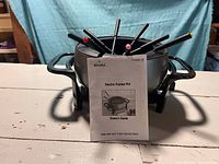 Rival electric fondue pot on stand with eight forks and manual