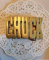 Front view showing CHUCK lettering and brass finish