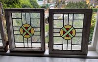 Both stained glass windows side by side on sill