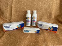 Lot overview showing three Voltaren boxes and two Icy Hot foam bottles