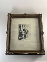 Framed Rembrandt etching print in ornate gold-tone wood frame with visible chipping
