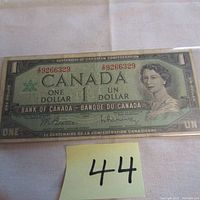 Photo of the full front face of the 1967 Canadian one dollar bill featuring Queen Elizabeth II and serial number.