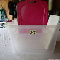 Clear large plastic storage bin with red lid, showing lid off to side and unit empty