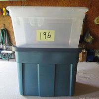 Two stacked storage bins, translucent white bin on top of blue Rubbermaid bin