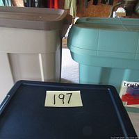 Large brown and large teal storage bins shown side by side, both with lids.
