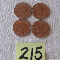 Four 1991 $1 trade tokens featuring Sir John A. Macdonald, arranged in a square on a fabric surface with a post-it note marked 215.