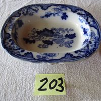 Top view of the oval flow blue candy dish showing overall shape and interior pattern with floral and architectural design.