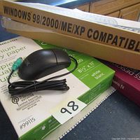 Mouse and boxes of copy paper including Windows compatible paper packaging