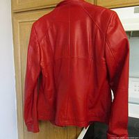 Back view of the red leather jacket, showing stitching and fit.
