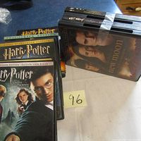 Photo of stacked DVDs showing multiple Harry Potter movies and Twilight DVDs with character covers.