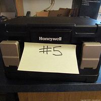 Front view showing Honeywell brand logo and beige latch covers with a sticky note #5 attached.