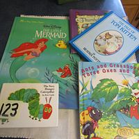 Photo showing large format hard cover The Little Mermaid, The Tale of Tom Kitten, numbers book, The Very Hungry Caterpillar and Aesop's Fables.