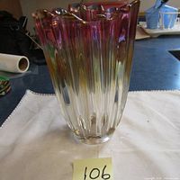 Image showing full view of a vintage thick glass vase with a ribbed pattern and a multicolor gradient from clear to amber to reddish-purple.