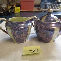 Front view of cream pitcher and sugar bowl showing shape, color, and details