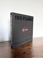 Closed hardcover book showing front cover with title, author, and Harley Davidson logo.