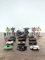 Full lot showing 5 action figures and 15 toy vehicles including cars and helicopter