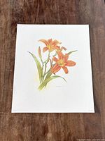 Full view of the Glen Loates Day Lily art print on a wooden surface.