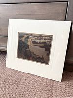 Sealed matted print titled 'The Solemn Land' by J.E.H. Macdonald with a white textured mat placement.