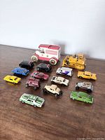 Overview of 12 vintage ERTL diecast toy vehicles on flat surface, showing variety and types