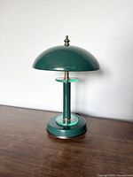 Full side view of green mushroom UFO table touch lamp showing base, stem with acrylic rings, and dome-shaped shade with finial