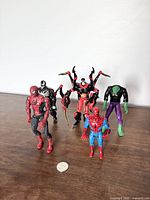 Group photo of five Spider-Man and villain action figures showing scale and condition.