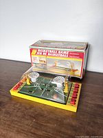 Photo of vintage tabletop basketball game with box in background