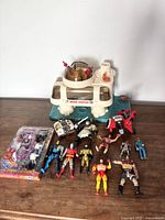 Full lot layout with Space Station playset, action figures, and packaged toy vehicle visible on wooden surface.