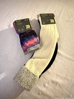 Front view of both unopened sock packs showing colours and packaging