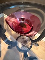 Overhead view of cranberry art glass dish showing folded rim and color