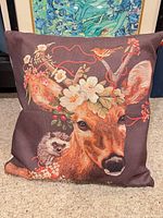 Front view of deer throw pillow with decorative print